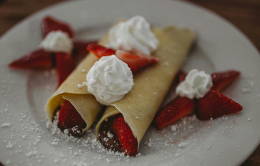 Golden crepes with whipped cream and strawberries to remind us of Valentine's Day